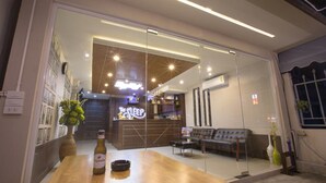Un interior moderno con una mesa de madera, una botella y un sofá.