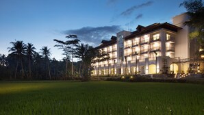 A multi-story hotel with a modern architectural design, featuring balconies and large windows. - Plataran Heritage Borobudur Hotel (Borobudur)