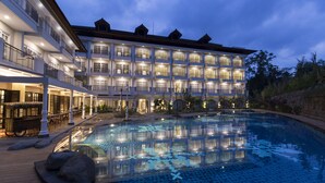 A large, multi-story hotel with a swimming pool and outdoor seating area. - Plataran Heritage Borobudur Hotel (Borobudur)