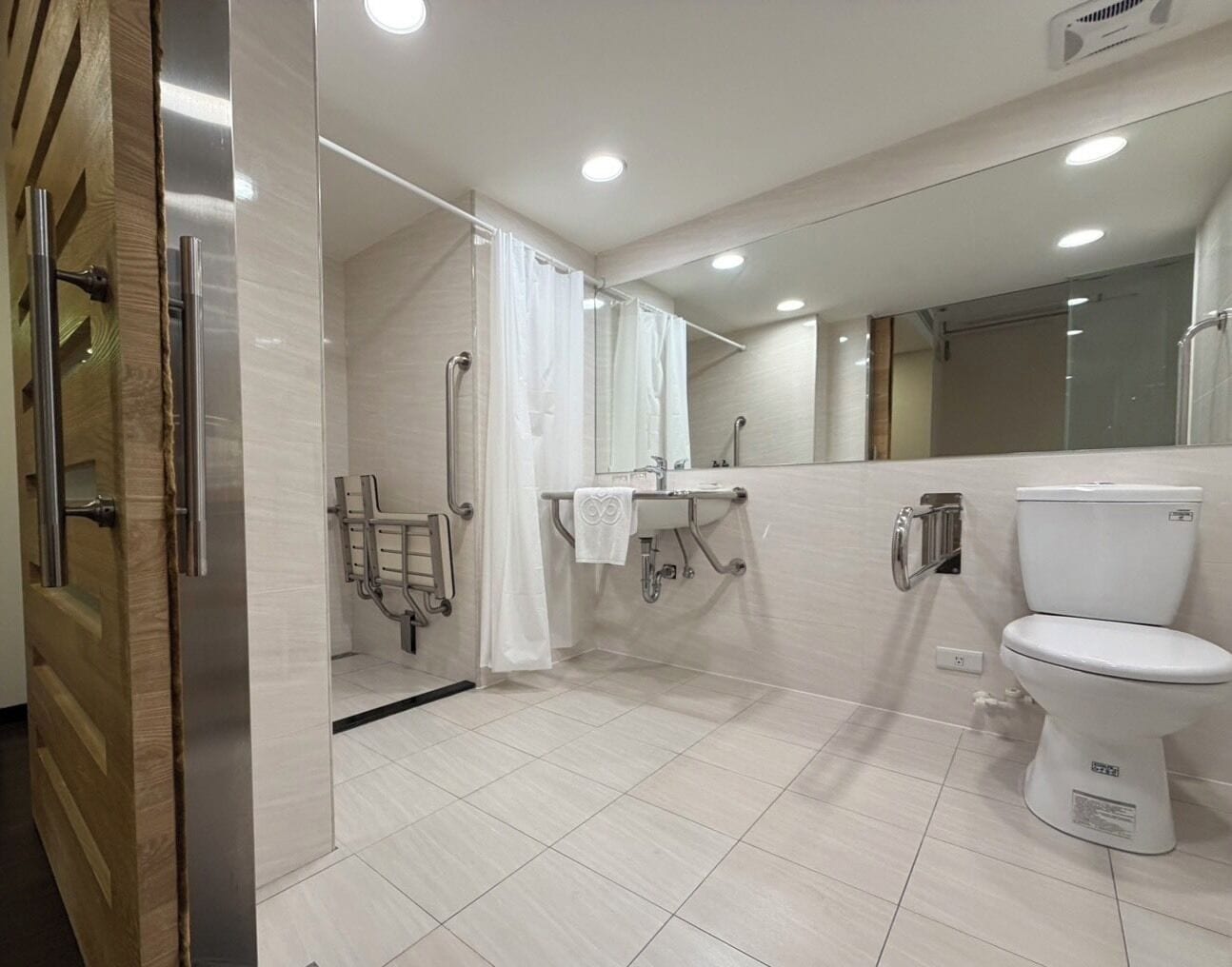 A modern bathroom with a shower, toilet, and sink.