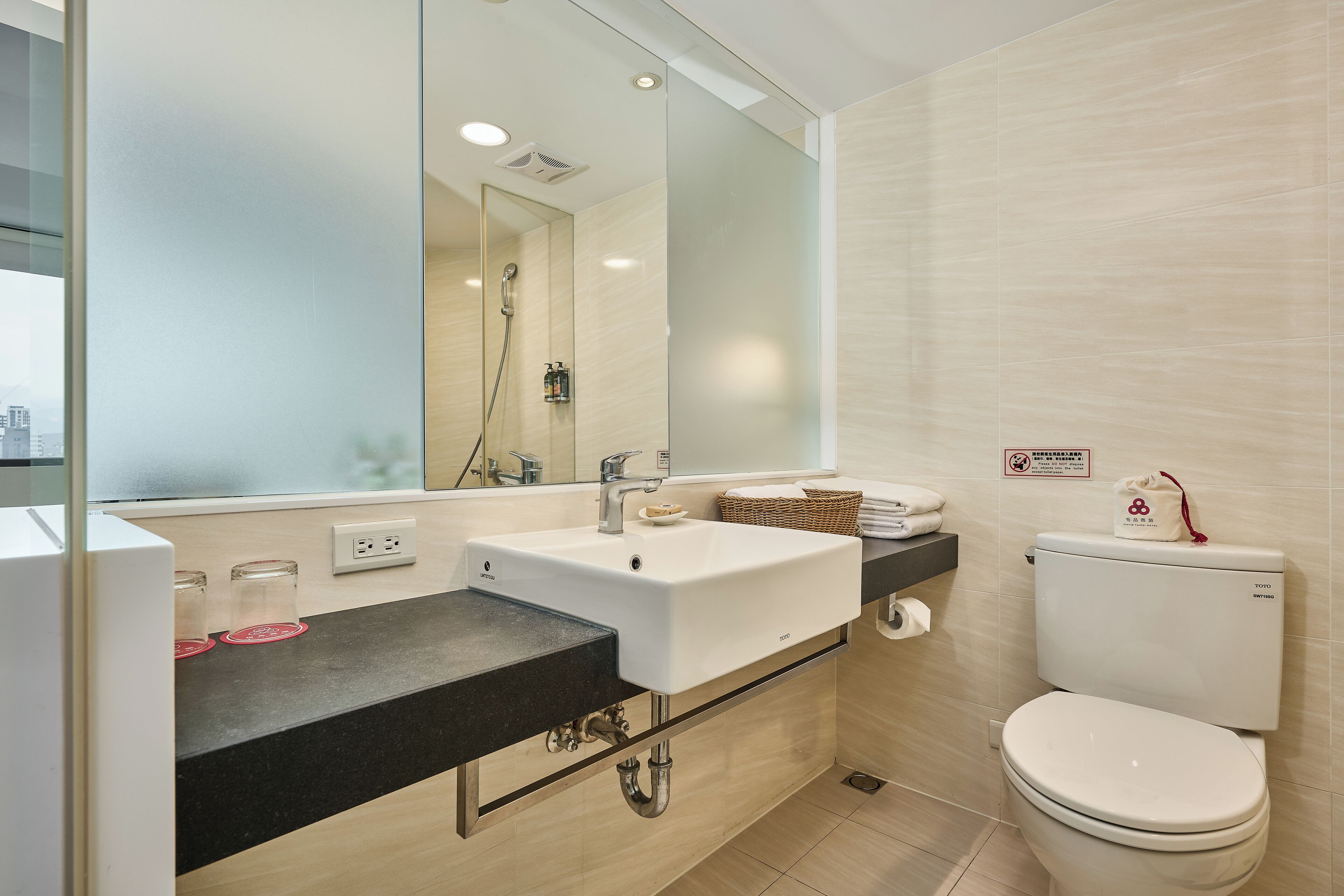 standard twin room | bathroom | designer toiletries, hair dryer, slippers, towels