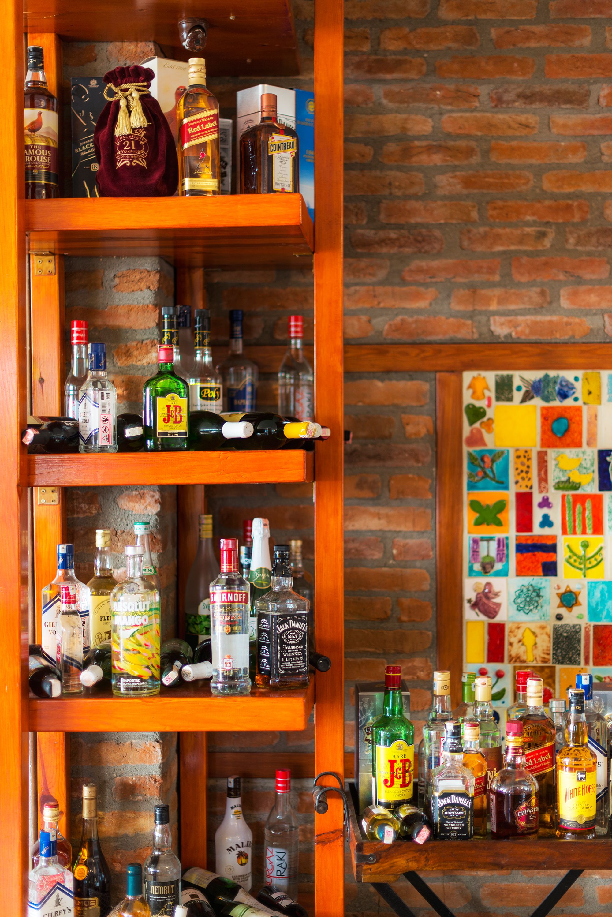 A wooden liquor shelf with various bottles.