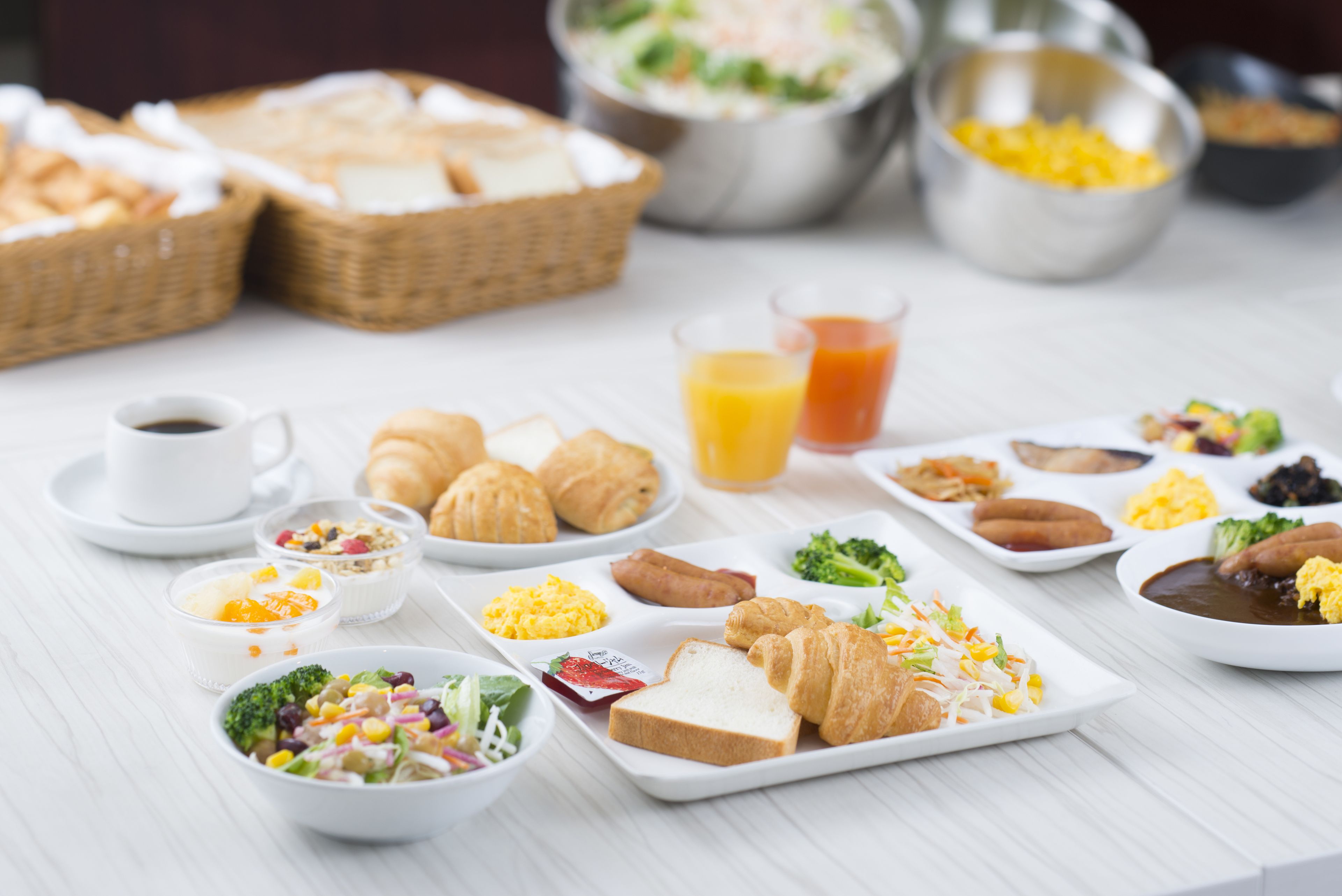 A breakfast buffet with various food items and beverages.