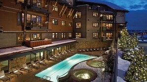A hotel with a pool area, outdoor seating, and a Christmas tree. - Mount Yale 611 4 BedroomCondo By Moving Mountains (Steamboat Springs)