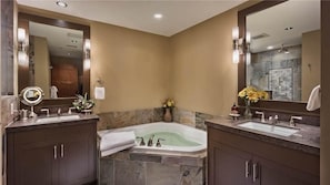 A modern bathroom with two sinks, a large bathtub, and a mirror. - Emerald Mountain 702 4 BedroomCondo By Moving Mountains (Steamboat Springs)