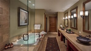 A modern bathroom with a large bathtub, a vanity with a bowl sink, and multiple mirrors. - Summit Peak Penthouse 803 4 BedroomCondo By Moving Mountains (Steamboat Springs)