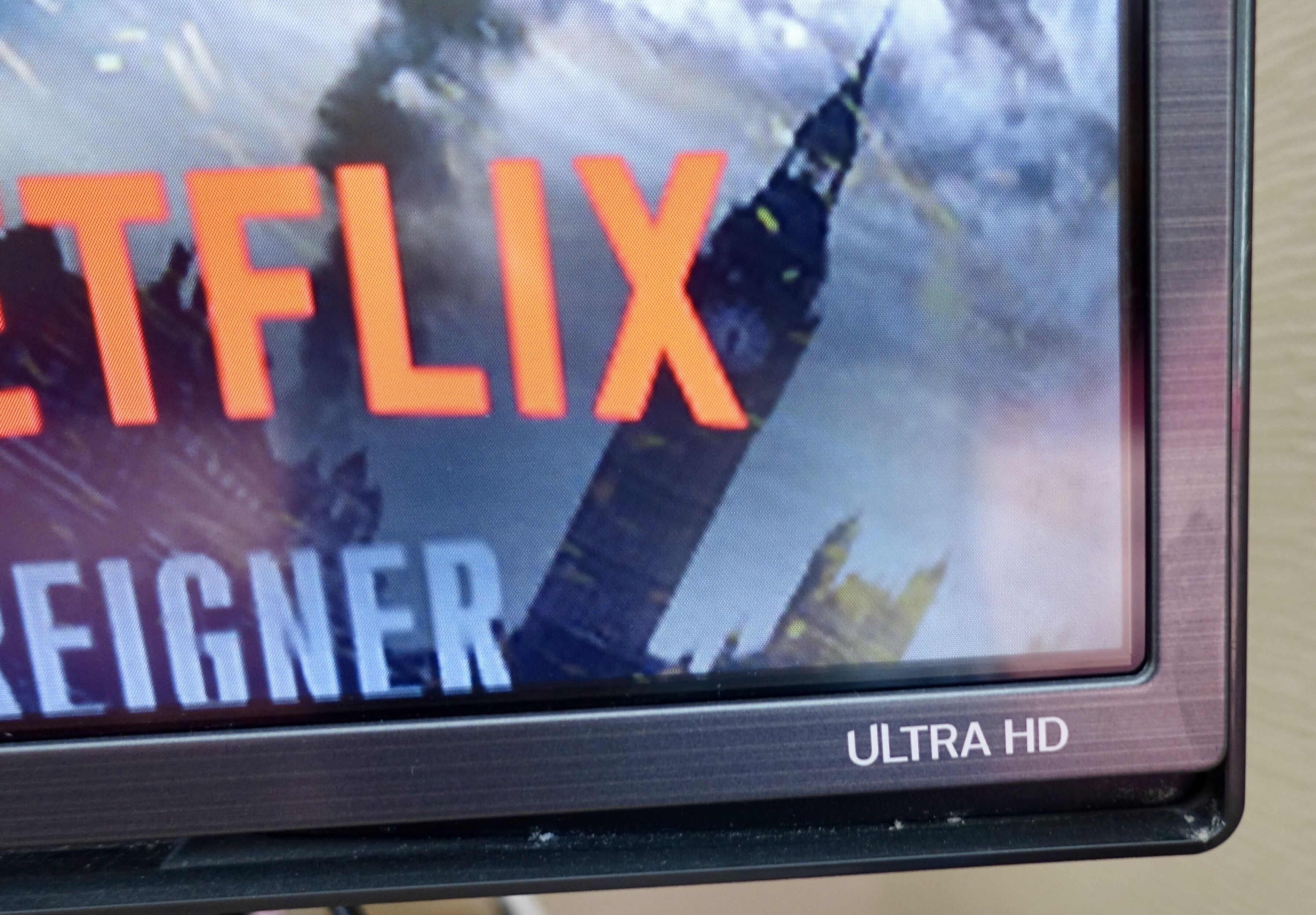 A television screen displaying the Netflix logo with the title "REIGNER" and "ULTRA HD" text.