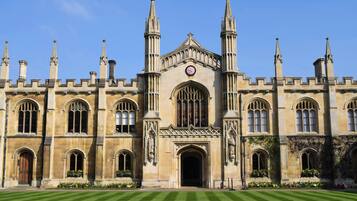 A historic building with a symmetrical facade, tall spires, and arched windows.
