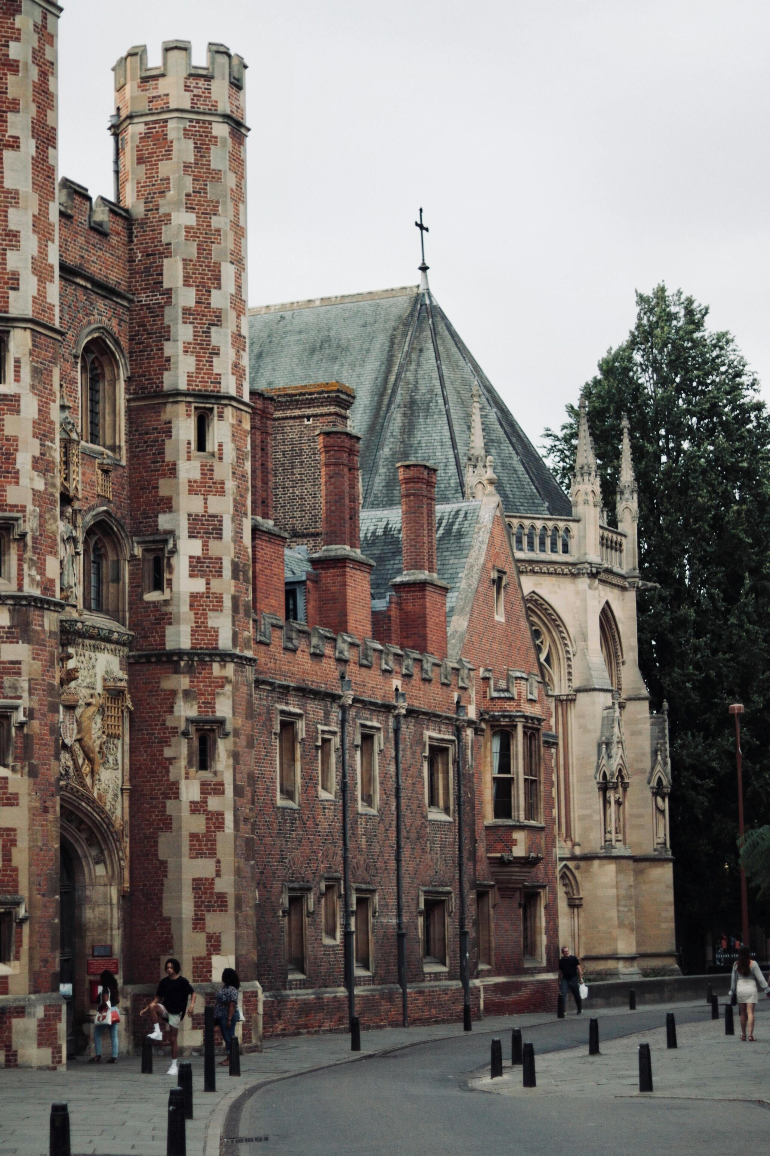 A historic building with a prominent tower and arched windows.
