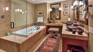 A modern bathroom with a glass-enclosed shower, a freestanding bathtub, a vanity with a large bowl sink, and a mirror with wall-mounted lights. - Hahns Peak 417 4 BedroomCondo By Moving Mountains (Steamboat Springs)