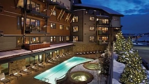 A hotel with a pool area, outdoor seating, and a Christmas tree. - Sawtooth Mountain 514 4 BedroomCondo By Moving Mountains (Steamboat Springs)