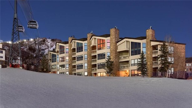 A multi-story hotel with a ski lift in the background, indicating a location near a ski resort. - Argentiere 341 3 BedroomCondo By Moving Mountains (Steamboat Springs)