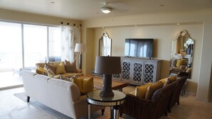 A spacious living room with a sofa, armchairs, a coffee table, and a television. - Las Mananitas LM 3 Villa 3501 3 Bedroom Villa By Seaside Los Cabos (San José del Cabo)