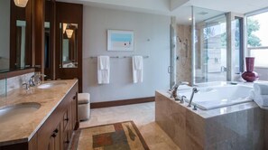 A modern bathroom with two sinks, a large bathtub, and a glass shower enclosure. - 104A Waiulu Street Hualalai (Kailua-Kona)