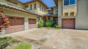 A residential area with multiple houses, each featuring a garage and a well-maintained lawn. - Fairways at Mauna Lani 1305 (Kamuela)