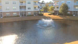 A multi-story building with balconies, a courtyard, and a water feature. - 223 Willow Bend (North Myrtle Beach)