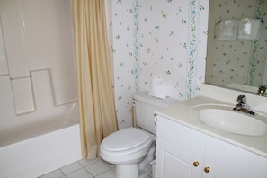 A bathroom with a toilet, sink, and bathtub. - 224 Wedgewood (North Myrtle Beach)