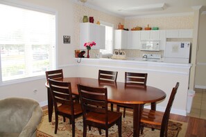 Enjoy meals in the spacious kitchen and dining area with a central dining table and comfortable seating.