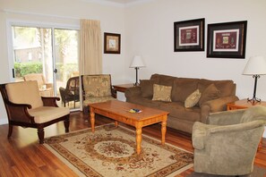 Relax in style with a comfortable sofa and armchair, perfect for unwinding in this inviting living space.