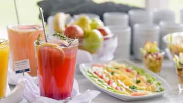 A breakfast buffet with various drinks and a salad.