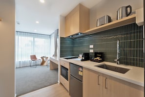 Premium Studio, 1 King Bed, Kitchen | Private kitchen | Mini-fridge, microwave, toaster, cookware/dishes/utensils