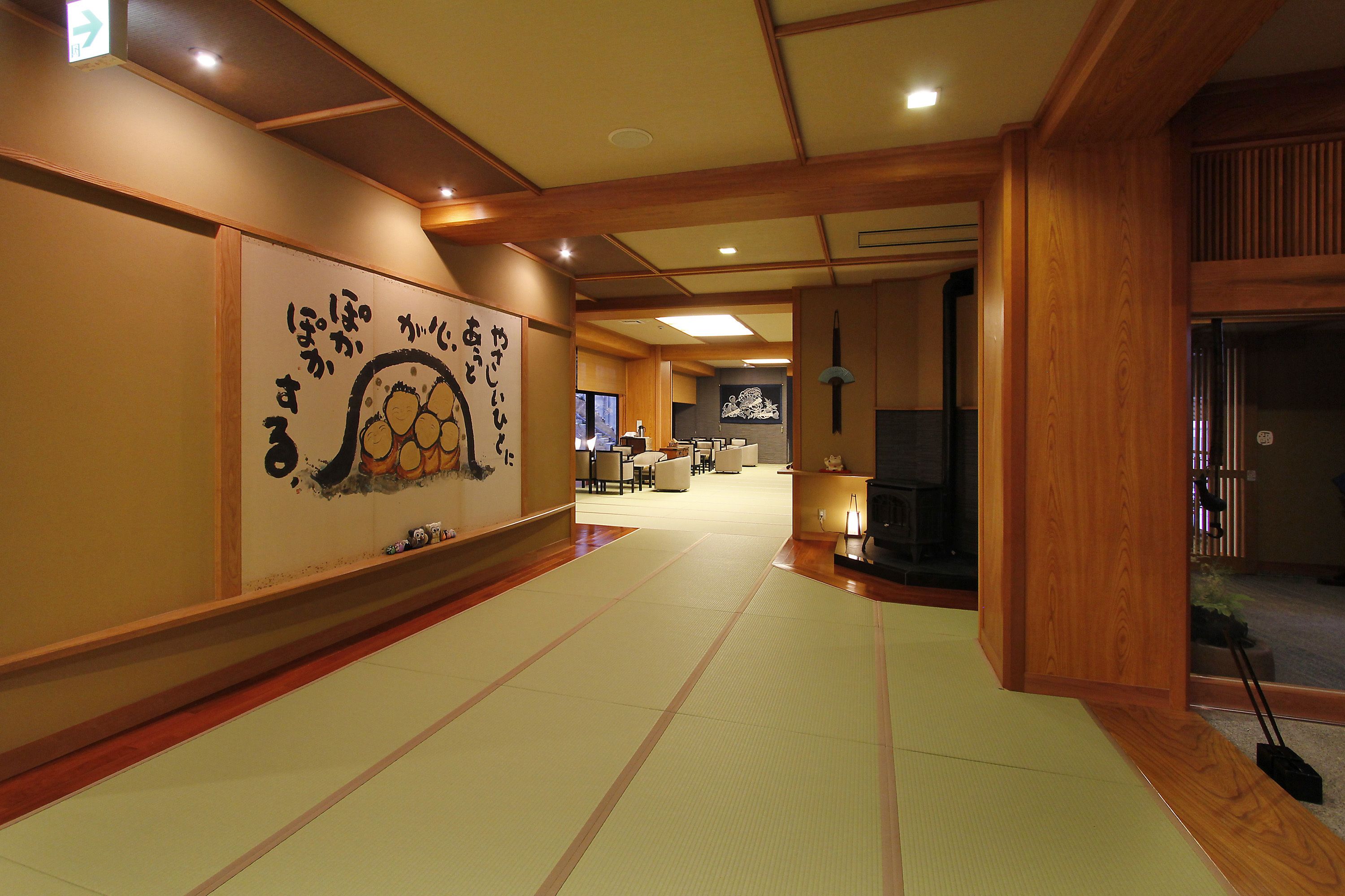 A traditional Japanese room with tatami flooring, a tatami mat display, and a wooden interior.