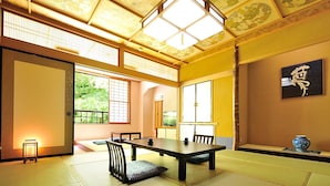 A traditional Japanese room with tatami flooring, a low table, and sliding doors. - Hinanoyado Chitose (Tokamachi)