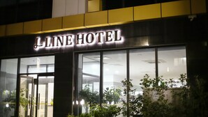 The exterior of the Line Hotel with its illuminated signage.