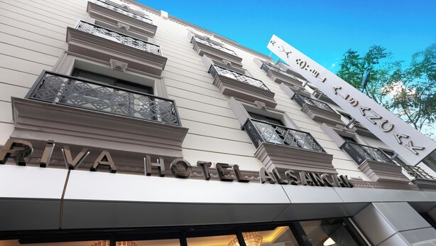 A hotel facade with the name 'RIVA HOTEL ASIAN' prominently displayed. - Riva Hotel Alsancak (Izmir)