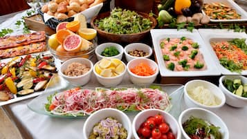 A buffet with various dishes including salads, meats, and vegetables.