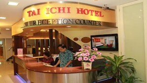 A reception counter at Tai Chi Hotel with a sign above it. - Tai Ichi Hotel (Kuala Lumpur)