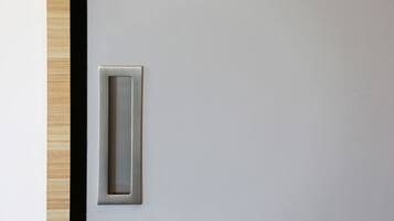 A door with a metallic handle and a textured surface.