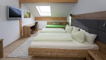 A bedroom with a loft bed, a desk, and a TV.