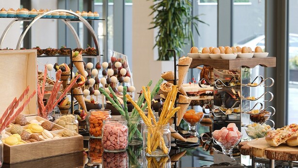 A buffet with various food items, including macarons, cookies, and desserts. - Radisson Blu Hotel Ankara Cankaya (Ankara)