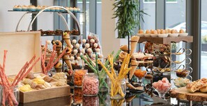 A buffet with various food items, including macarons, cookies, and desserts. - Radisson Blu Hotel Ankara Cankaya (Ankara)