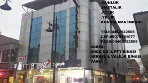 A building with a sign reading "APARTMENT" and "TEL" indicating a contact number. - Moonlight (Erzincan)