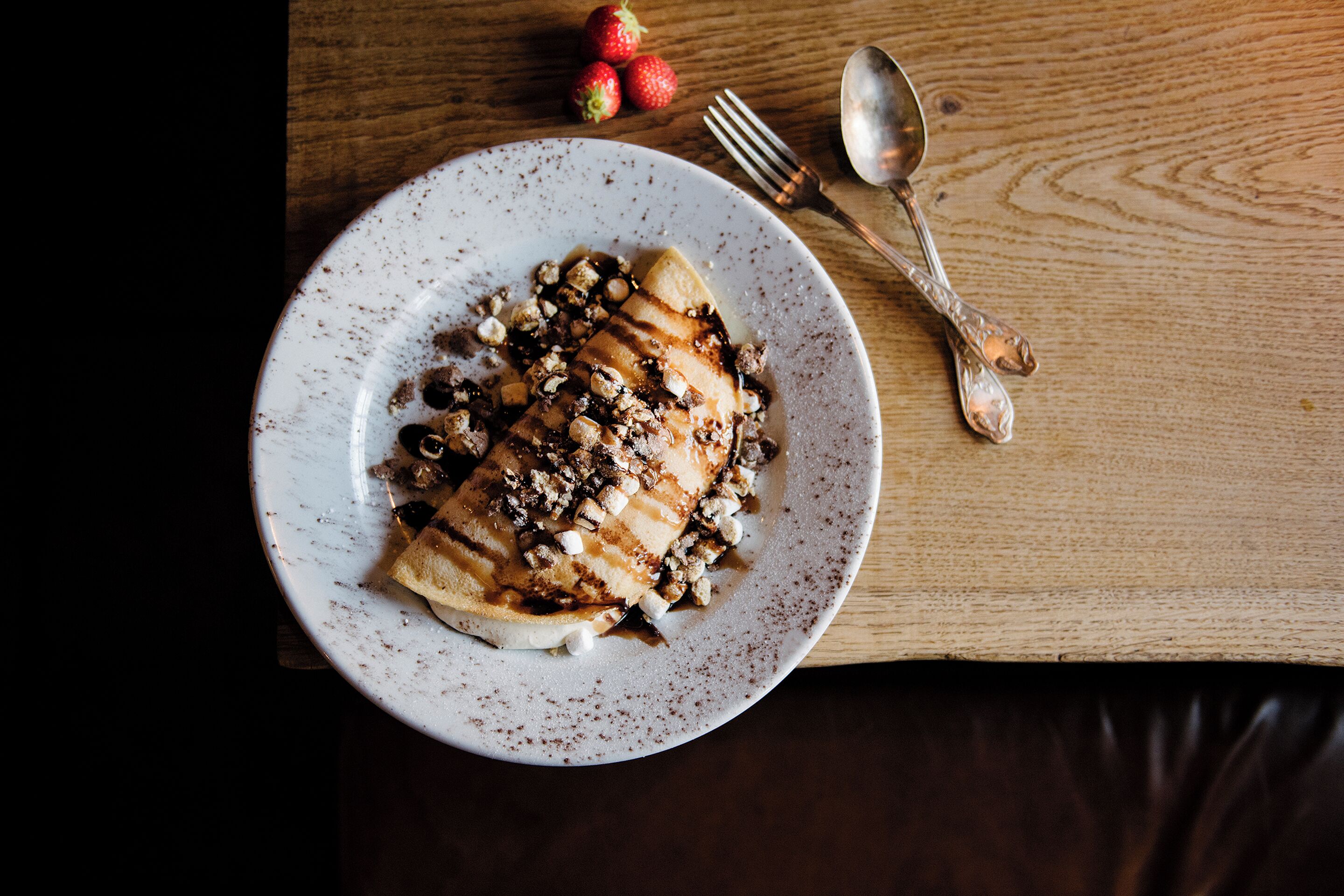 A plate of food on a wooden table.