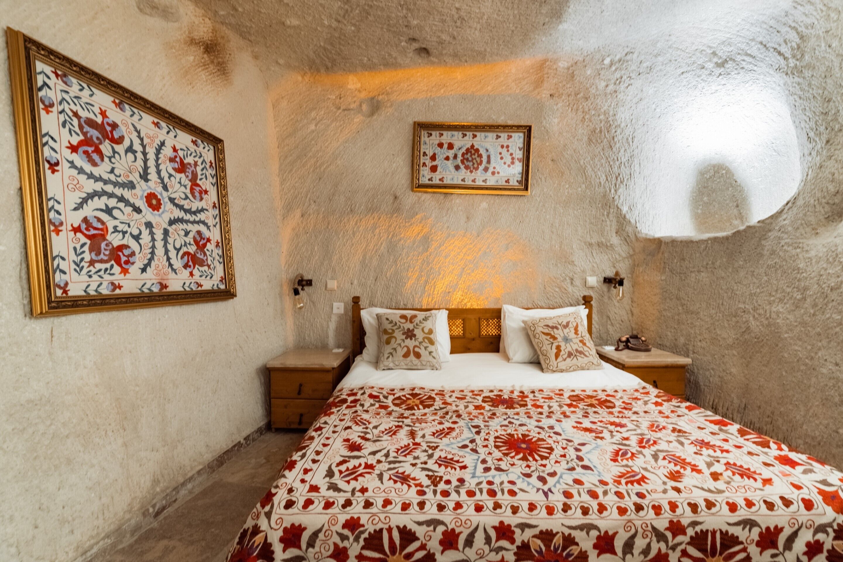 Un dormitorio con una cama grande, dos mesitas de noche y un cuadro colgado en la pared.