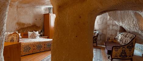 A room with a bed, a wooden cabinet, a chair, and a rug.