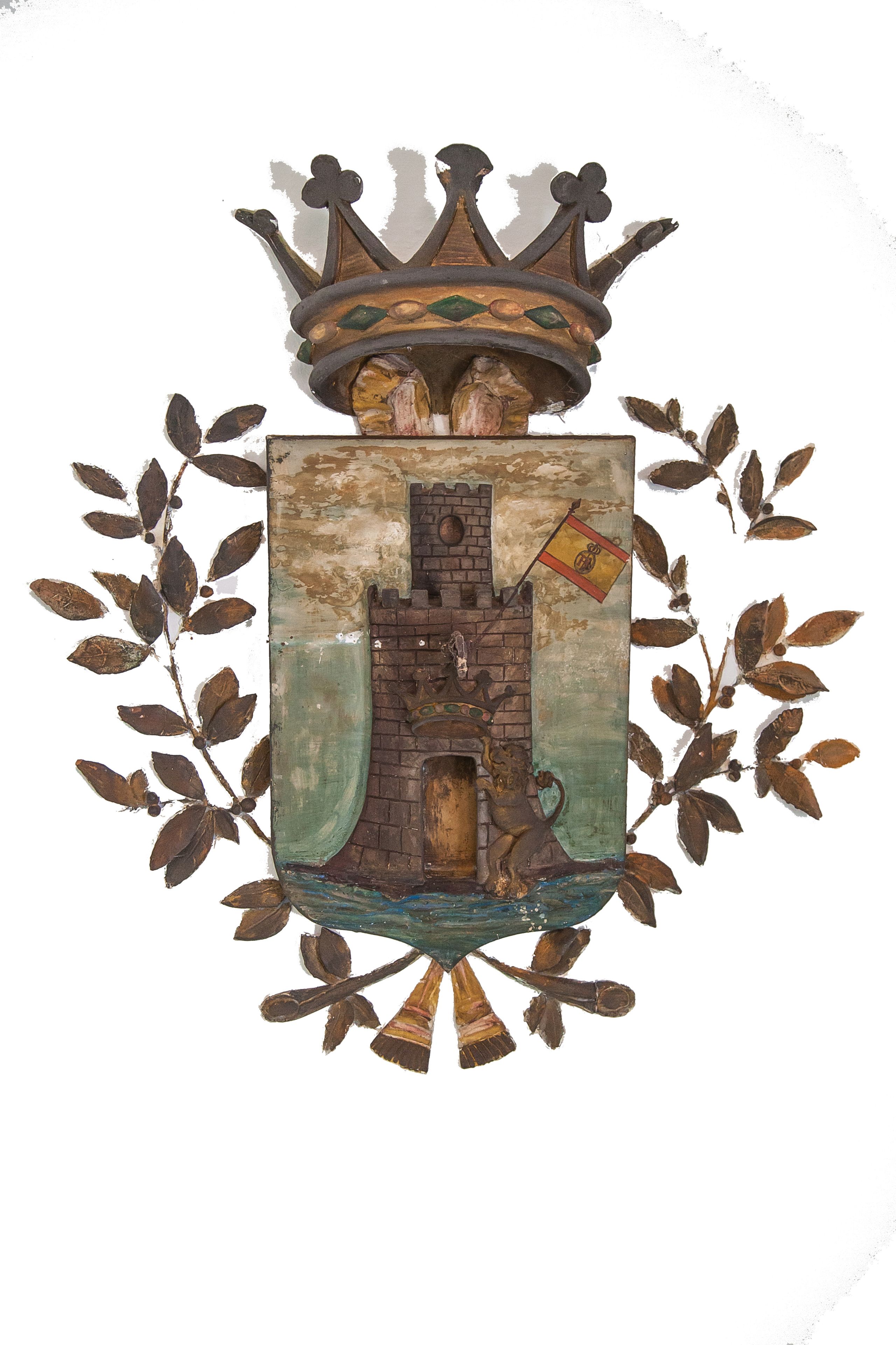 A heraldic coat of arms with a castle, a flag, and a crown.