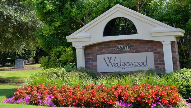 A brick building with a sign reading "Wedgewood" and the number "5751" above it. - 223 Wedgewood (North Myrtle Beach)
