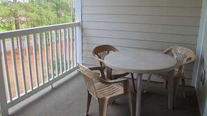 A covered outdoor area with a round table and four chairs. - 432 Willow Bend (North Myrtle Beach)