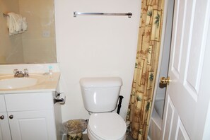 A bathroom with a toilet, sink, and mirror. - 432 Willow Bend (North Myrtle Beach)