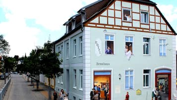 Experience the charm of a traditional European hotel, set amidst a picturesque street with a welcoming entrance.