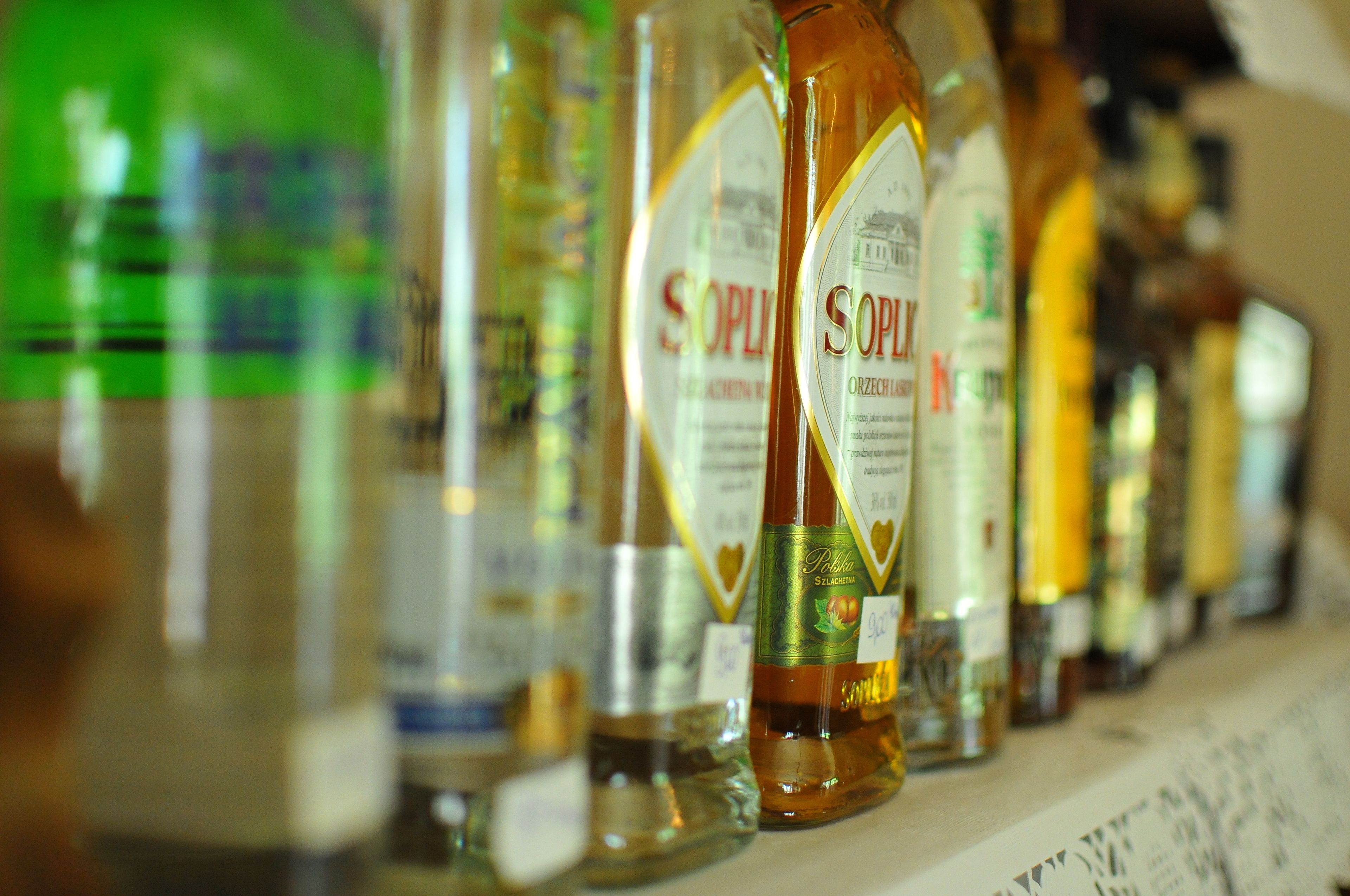 A row of liquor bottles on a shelf.