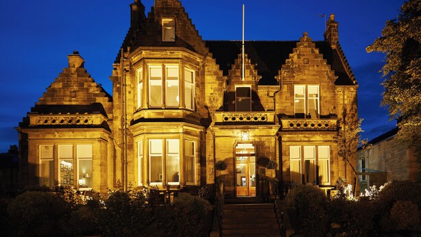 A historic building with a prominent corner turret, large windows, and a flagpole. - The Dunstane - No 4 (Edinburgh)
