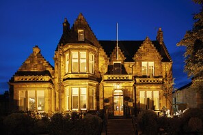 A historic building with a prominent corner turret, large windows, and a flagpole. - The Dunstane - No 4 (Edinburgh)