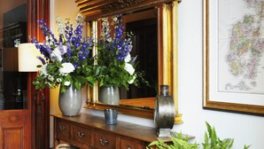 A wooden dresser with two vases of flowers, a mirror, and a framed map on the wall. - The Dunstane - No 4 (Edinburgh)