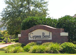 A sign for Cypress Bend with a brick arch and greenery around. - 1024 Cypress Bend (North Myrtle Beach)