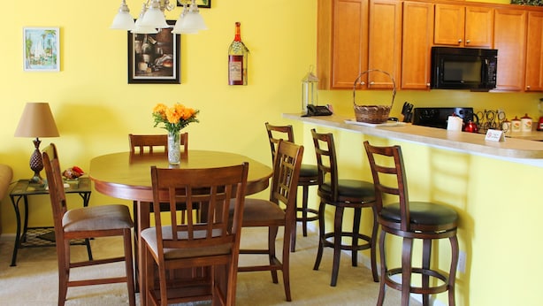 A dining area with a round table, wooden chairs, and a chandelier. - 1534 Willow Bend (North Myrtle Beach)